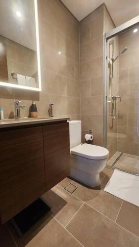 a bathroom with a toilet and a sink and a shower at STAY BY LATINEM Luxury 1BR Holiday Home CVR A703 near Burj Khalifa in Dubai