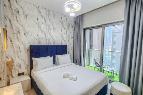 a bedroom with a large bed and a large window at STAY BY LATINEM Luxury 1BR Holiday Home CVR A703 near Burj Khalifa in Dubai