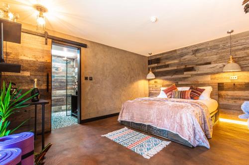 a bedroom with a wooden accent wall and a bed at Fermain Valley Hotel in St. Peter Port