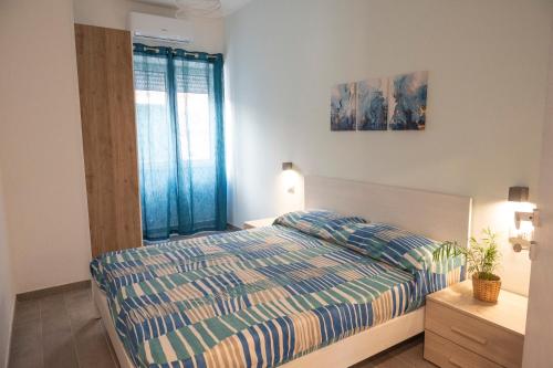 a bedroom with a bed and a window at antica dogana apartments scirocco in Terracina