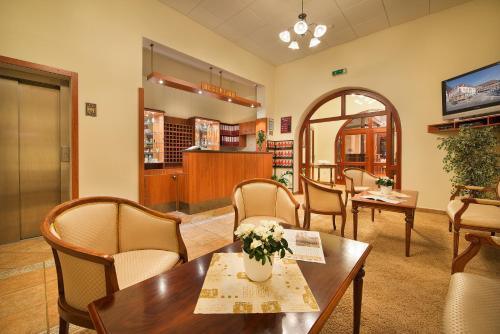 a waiting room with a table and chairs at Hotel Podhrad in Hluboká nad Vltavou