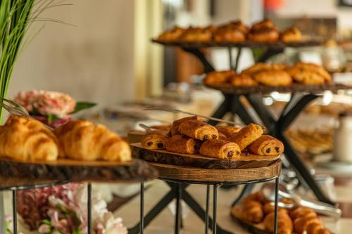 a display of pastries and croissants on plates in a bakery at Hotel Della Torre in Stresa