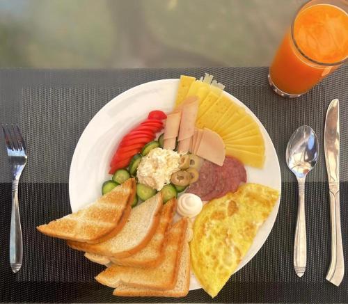 a plate of food with meat and vegetables and toast at sea view house in Marsa Alam City