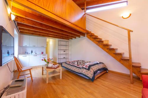 a bedroom with a bed and a staircase at Casa Gialla - Happy Rentals in Pugerna