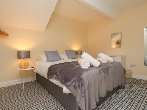 a bedroom with a large bed with two pillows at Suite 14 in Blackpool