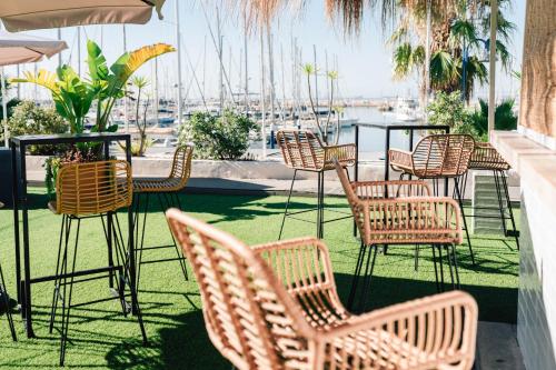 a group of chairs and tables on a patio at Hotel Puerto Sherry in El Puerto de Santa María