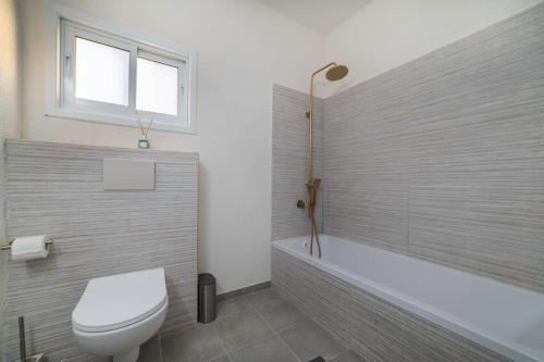 a bathroom with a toilet and a bath tub at Beachfront apartment with breathtaking sea view in Netanya