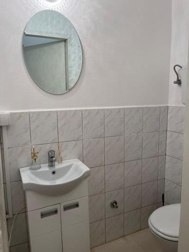 a bathroom with a sink and a mirror at Room Glorija 2 in Pančevo