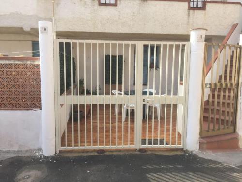 a gate in front of a house at L' APPARTAMENTO sul MARE in Agnone Bagni