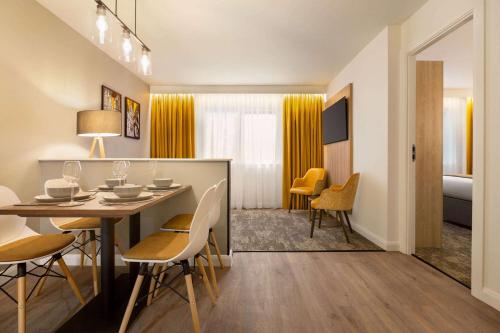 a dining room with a table and chairs at Super 8 by Wyndham Chester East in Chester