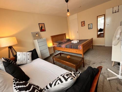 ein Wohnzimmer mit 2 Betten und einem Tisch in der Unterkunft Millfields Place in London