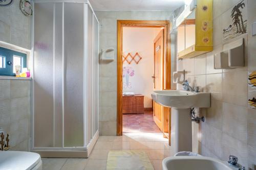 a bathroom with a sink and a toilet at Torre di Calasetta Cozy Apartment in Calasetta