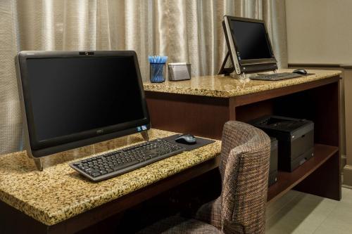 a desk with a computer monitor and a keyboard and mouse at Residence Inn Houston Downtown/Convention Center in Houston