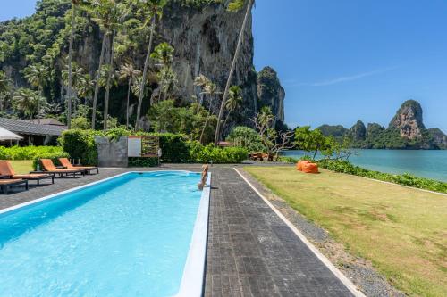 a pool with a view of the water and a mountain at Tinidee Hideaway Tonsai Beach Krabi - SHA Extra Plus in Tonsai Beach