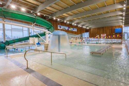 an indoor swimming pool with a water slide at Microtel Inn & Suites by Wyndham Summerside in Summerside
