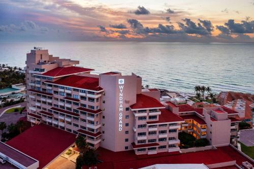 an aerial view of a building by the ocean at Wyndham Grand Cancun All Inclusive Resort & Villas in Cancún