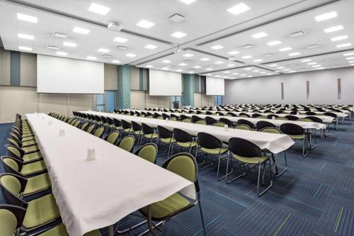 an empty lecture hall with tables and chairs at Microtel Inn & Suites by Wyndham Summerside in Summerside