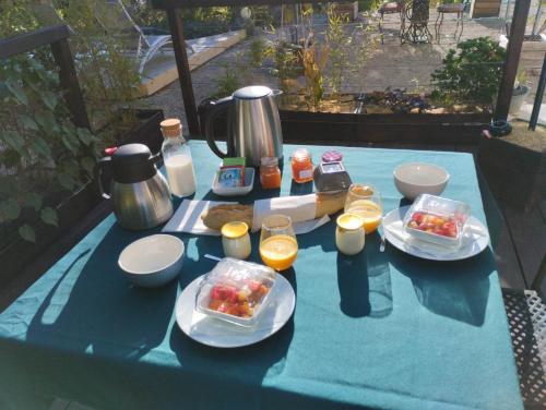 a blue table with food and drinks on it at La guitoune in Laroque