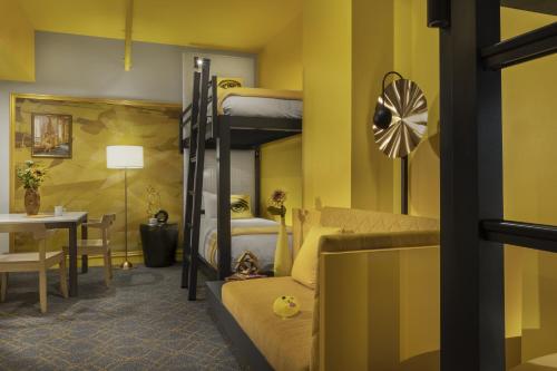 a living room with a bunk bed and a table at Angad Arts Hotel St Louis, Tapestry Collection by Hilton in Saint Louis