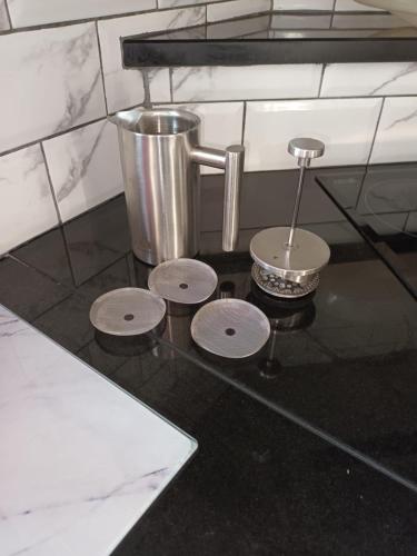 a counter top with four metal pots and a juicer at Four Winds,Kinsale Town,Exquisite holiday homes,sleeps 26 in Kinsale