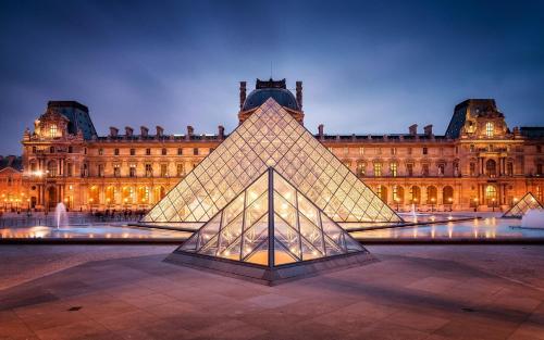 a pyramid in front of a large building at Kimpton - St Honoré Paris by IHG in Paris