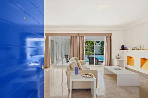 a living room with a couch and a table at Privè Royal Villa Bahiazul in Corralejo