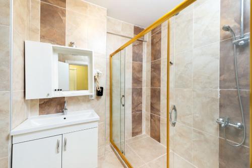 a bathroom with a shower and a sink and a mirror at Grand Abimo Hotel in Istanbul