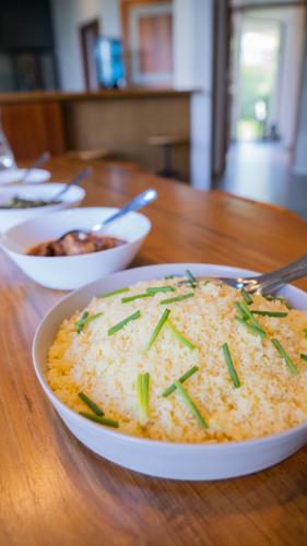 a bowl of rice on a wooden table at LAKE VILLA by CARLSEN in Moratuwa