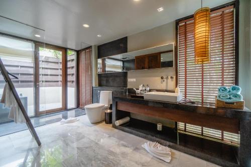 a bathroom with a sink and a toilet at Pattara Resort & Spa in Phitsanulok