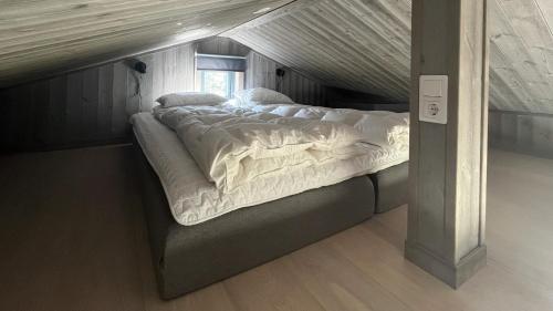 a large bed sitting in the middle of a room at Kåvanstugan Funäsdalen in Funäsdalen