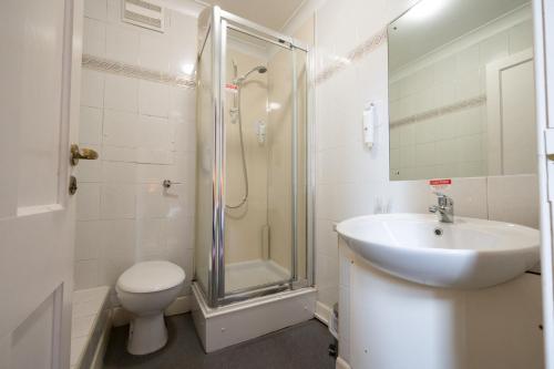 a bathroom with a sink and a shower and a toilet at Hampton Hotel by Greene King Inns in Edinburgh