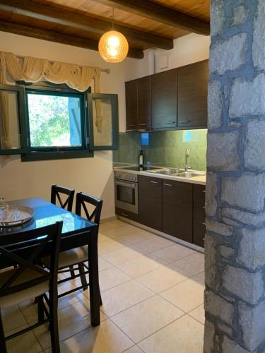 a kitchen with a table and a dining room at Petra Nova Villas in Mochlos