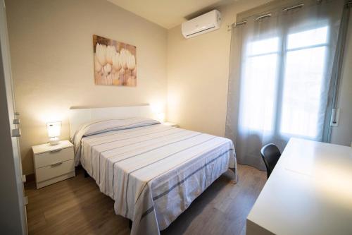 a small bedroom with a bed and a window at Sant Ferriol in Olot