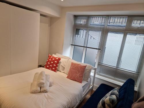 a bedroom with a bed with towels on it at Lovely 1-Bed Apartment in London in London