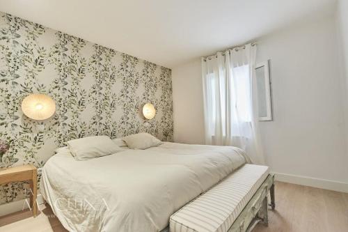 a bedroom with a bed with a bench in it at Apartamento Cervantes in Santander