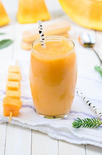 a glass of orange juice on a table at LAKE VILLA by CARLSEN in Moratuwa