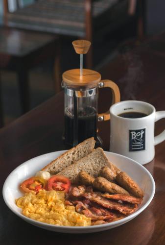 a plate of breakfast food and a cup of coffee at LAKE VILLA by CARLSEN in Moratuwa