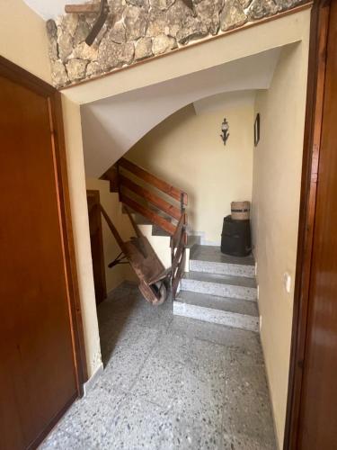 a hallway with stairs and a stone wall at Mas del Llorenç in Ulldemolins