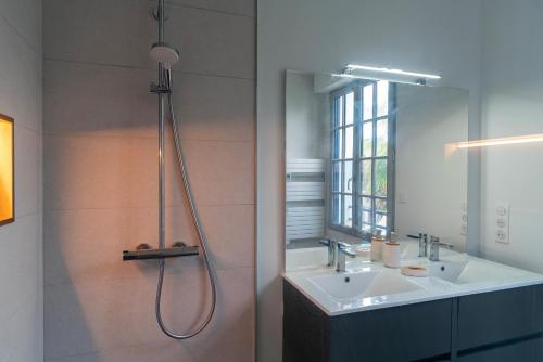 a bathroom with a shower and a sink and a mirror at La Mouette - Appartement à 100m de la plage in Bénodet