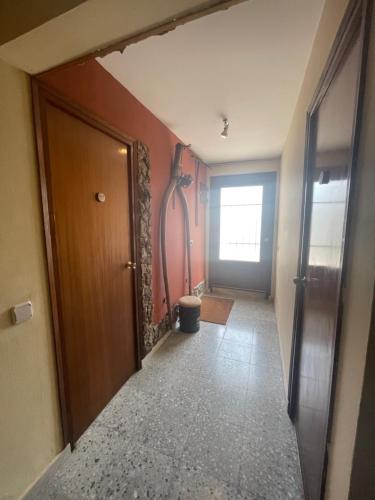 a hallway with a wooden door and a hallway with a door at Mas del Llorenç in Ulldemolins