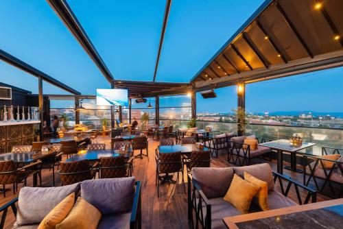 ein Restaurant mit Tischen, Stühlen und Fenstern in der Unterkunft Grand Abimo Hotel in Istanbul