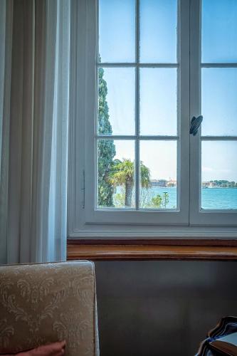 a window in a room with a view of the water at Hotel Villa Mabapa in Venice-Lido