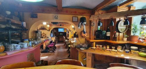 a restaurant with a bar and a counter with chairs at Edinburgh in Mariánské Lázně