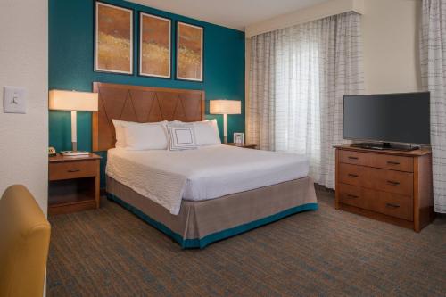 a bedroom with a bed and a flat screen tv at Residence Inn Chantilly Dulles South in Chantilly