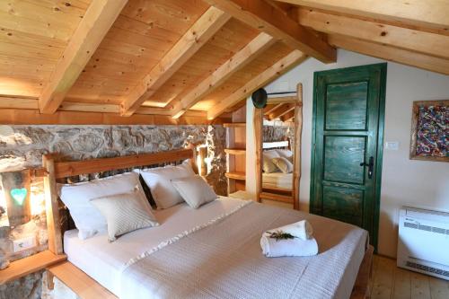 a bedroom with a large bed and a green door at Villa Teza Hvar in Hvar