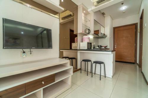a kitchen with a bar and stools in a room at Exclusive and Cozy studio in central Jakarta in Jakarta