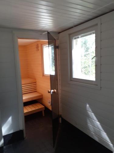 a small room with a sauna with a window at Huone Seesteisessä Mummolassa in Kalajoki