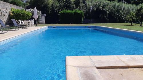 une grande piscine bleue dans une cour dans l'établissement Didgy 5 personnes, à Pont-Saint-Esprit