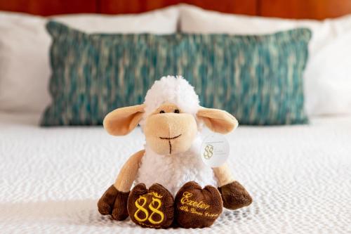 a stuffed animal lamb sitting on a bed at Courtyard Boston Copley Square in Boston