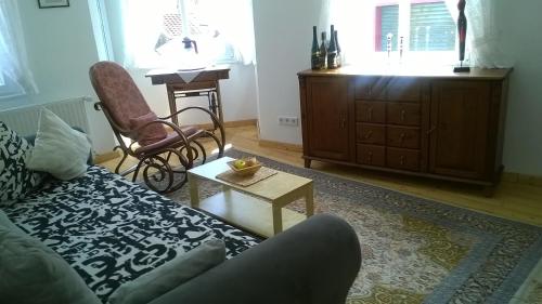 a living room with a couch and a table at Am Bungert in Mayschoß